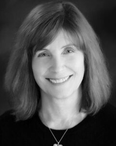Portrait of Dr. Anita Morgan, smiling while wearing a black shirt and necklace.